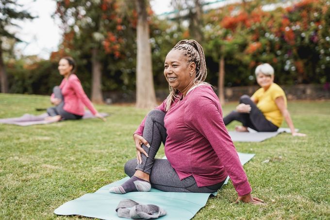 A group of women embracing positive aging by doing yoga.