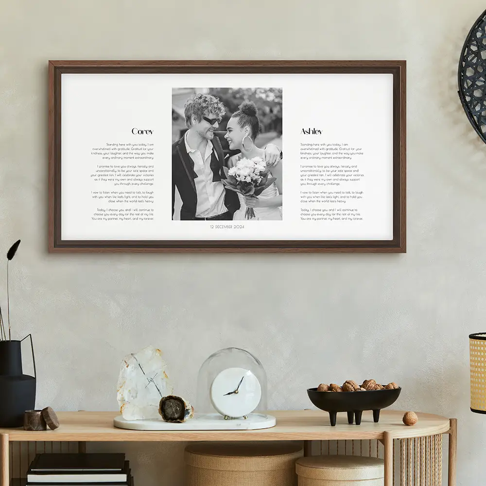 a framed photo of a couple kissing in front of a clock