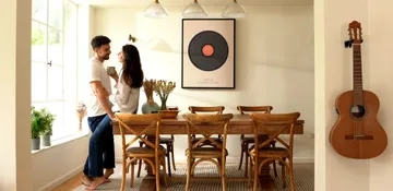 a man and a woman standing in front of a table