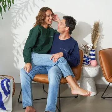 a man and a woman sitting on a chair