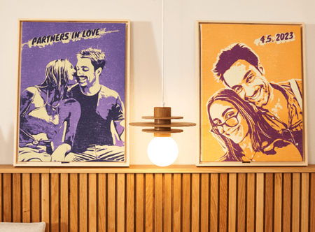 a couple of posters on a wall above a bed