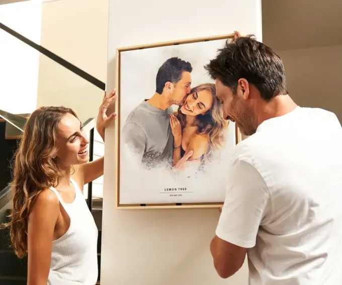 a man standing next to a woman in front of a poster