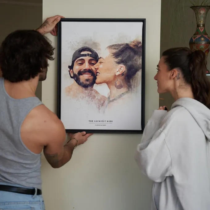 a man and a woman looking at a portrait of a man and woman