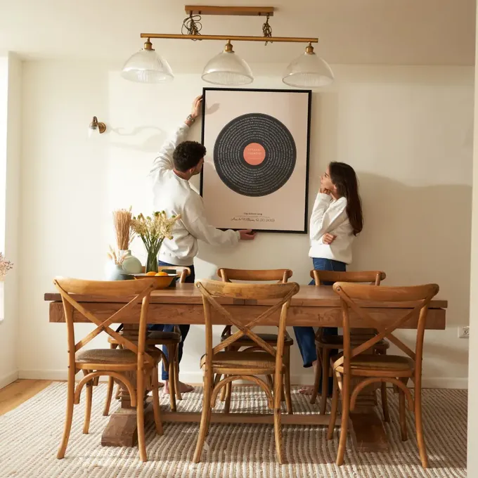 a man and a woman standing in front of a table