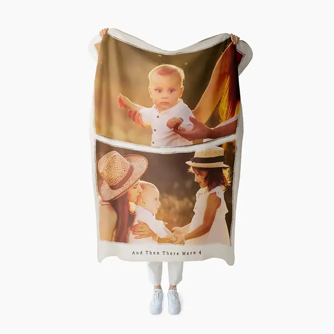 a woman is holding a towel with a picture of a baby