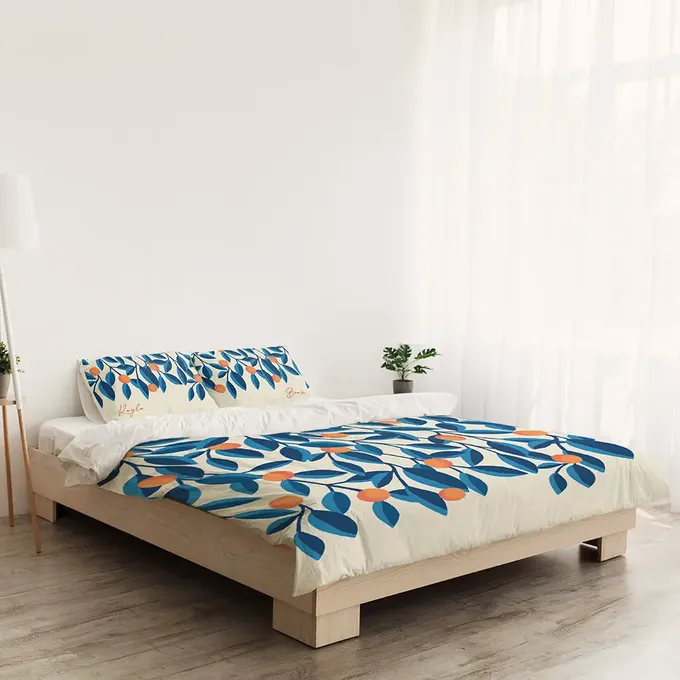 a bed with a blue and orange comforter in a white room