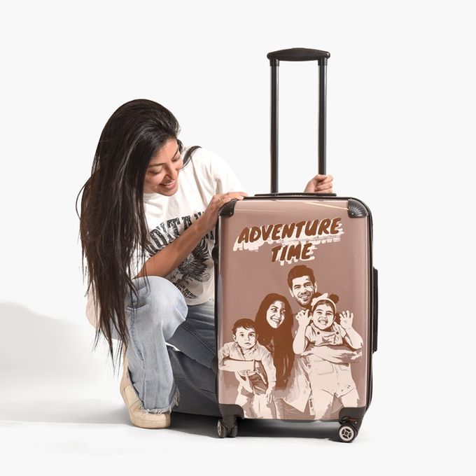 a woman kneeling down next to a piece of luggage