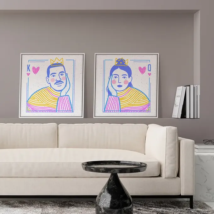 a living room with a couch and two paintings on the wall