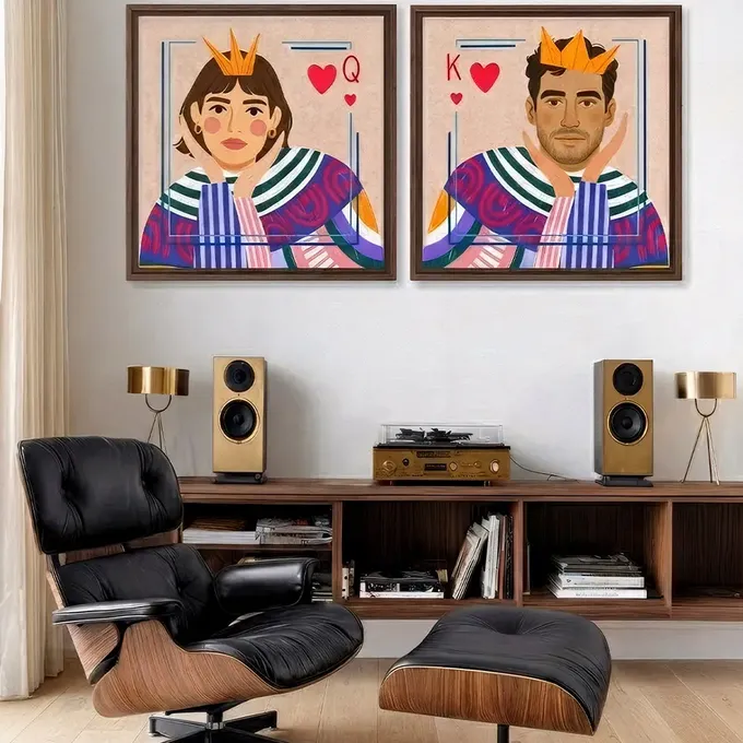 a living room with two paintings of a man and a woman