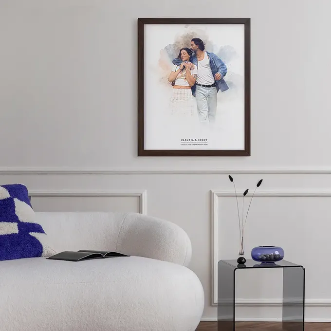 a living room with a white couch and a painting on the wall