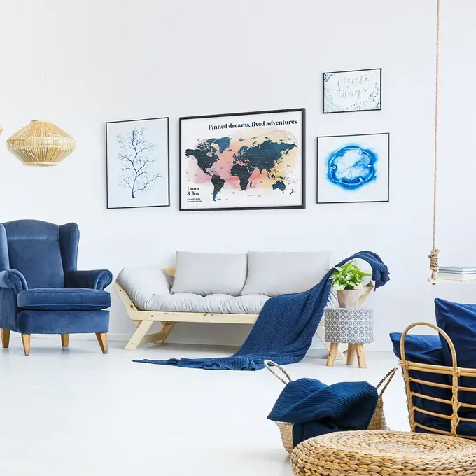 a living room filled with furniture and pictures on the wall