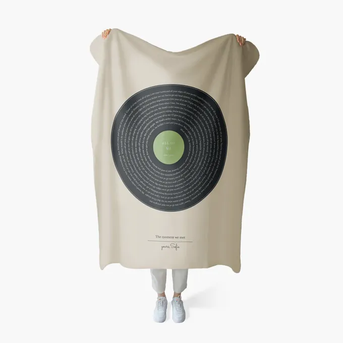 a person holding a blanket with a picture of a target on it