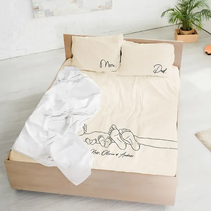 a bed with two pillows and a blanket on top of it