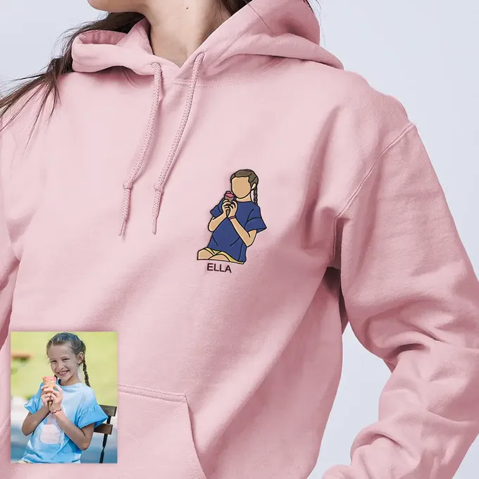 a woman wearing a pink hoodie with a picture of a girl on it