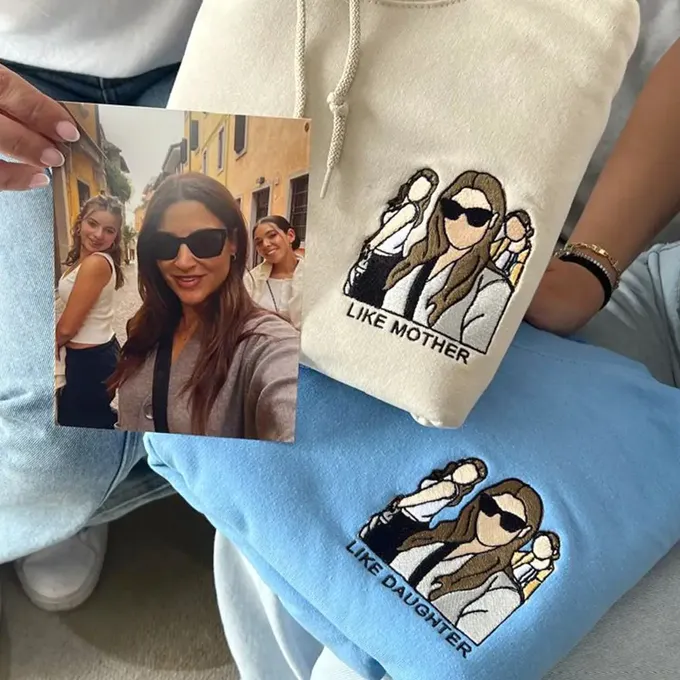 a woman holding a photo of herself on a pillow