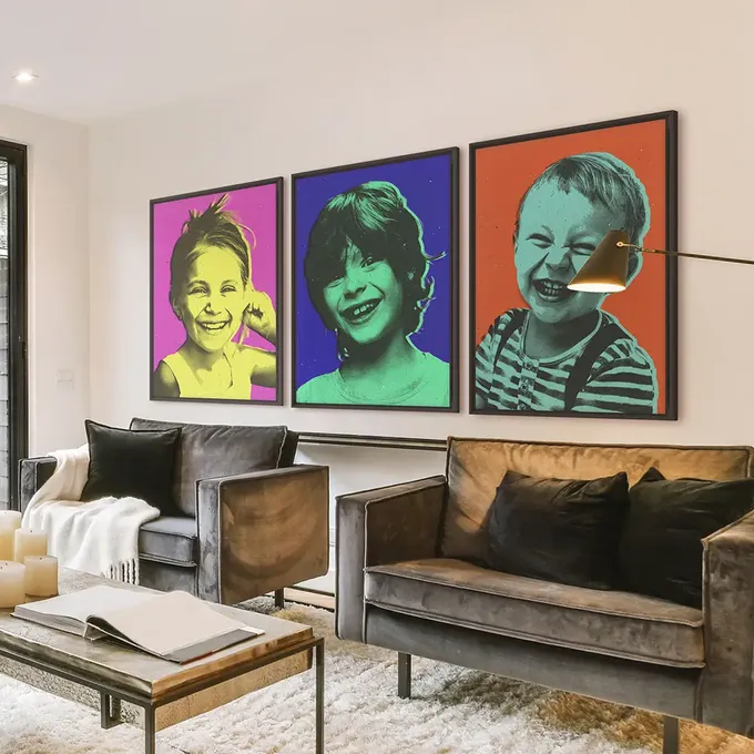 a living room filled with furniture and paintings on the wall