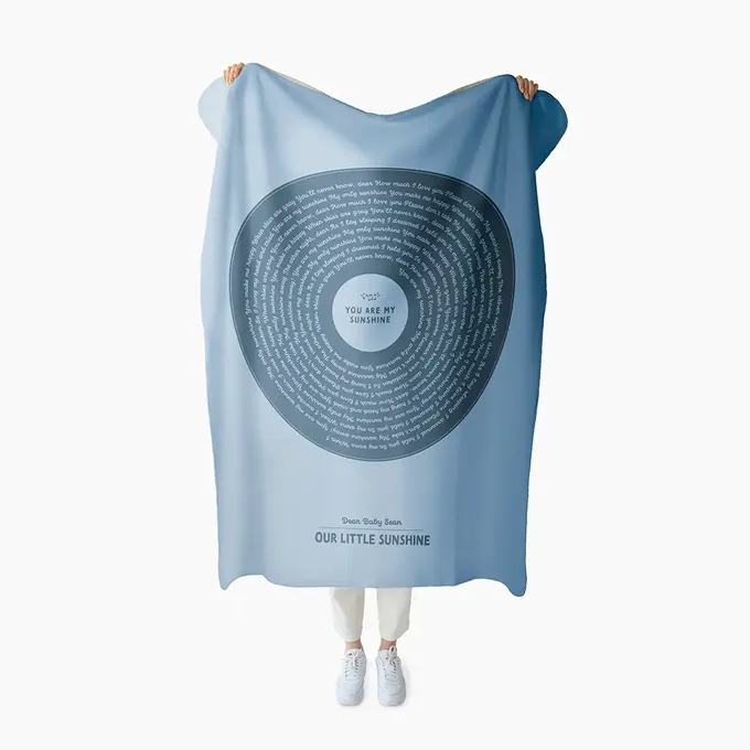 a woman holding a blue towel with a poem on it