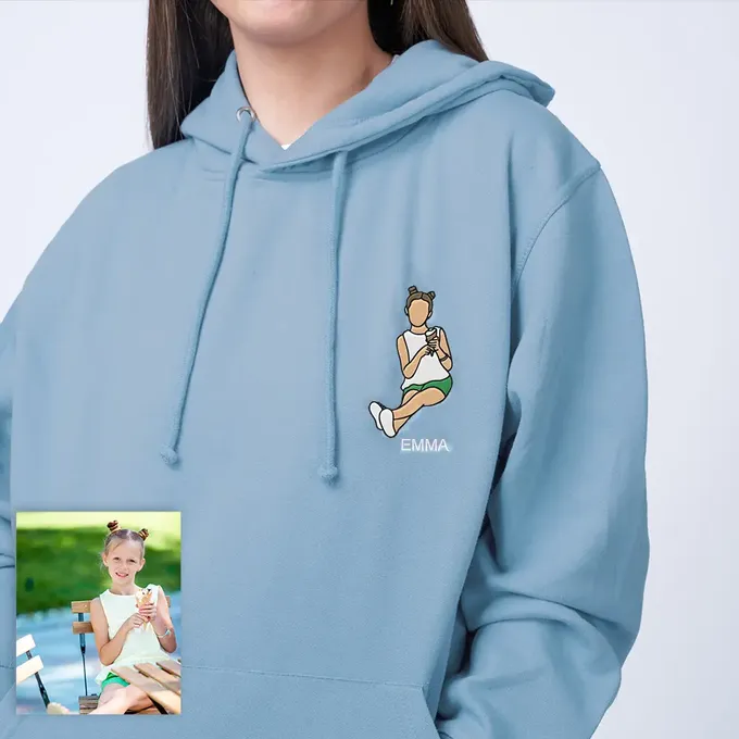a woman wearing a blue hoodie with a picture of a girl on it