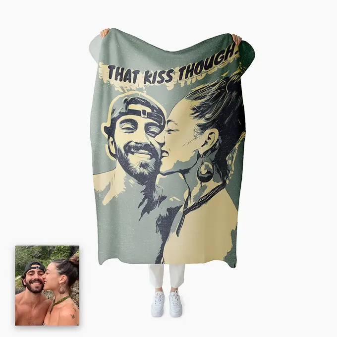 a man and a woman kissing under a blanket