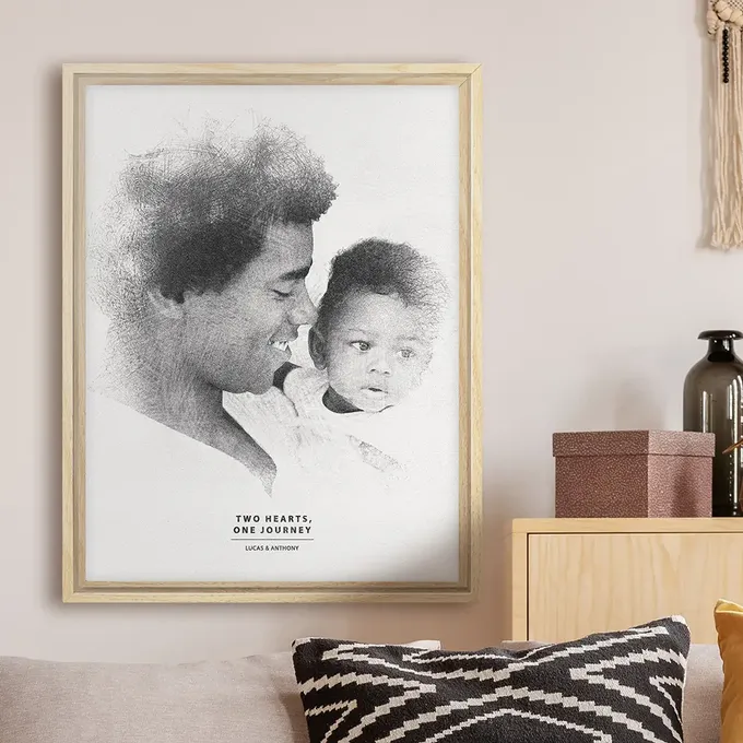 a black and white photo of a man holding a baby
