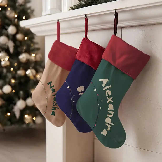 three christmas stockings hanging from a mantel