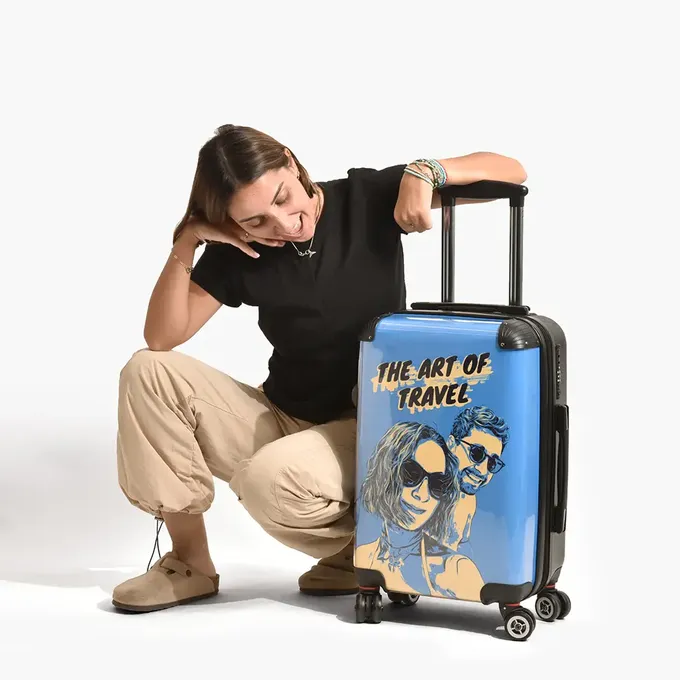 a woman kneeling down next to a piece of luggage