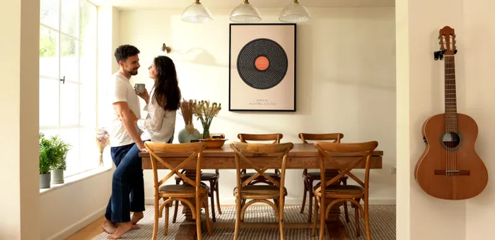 a man and a woman standing in front of a table