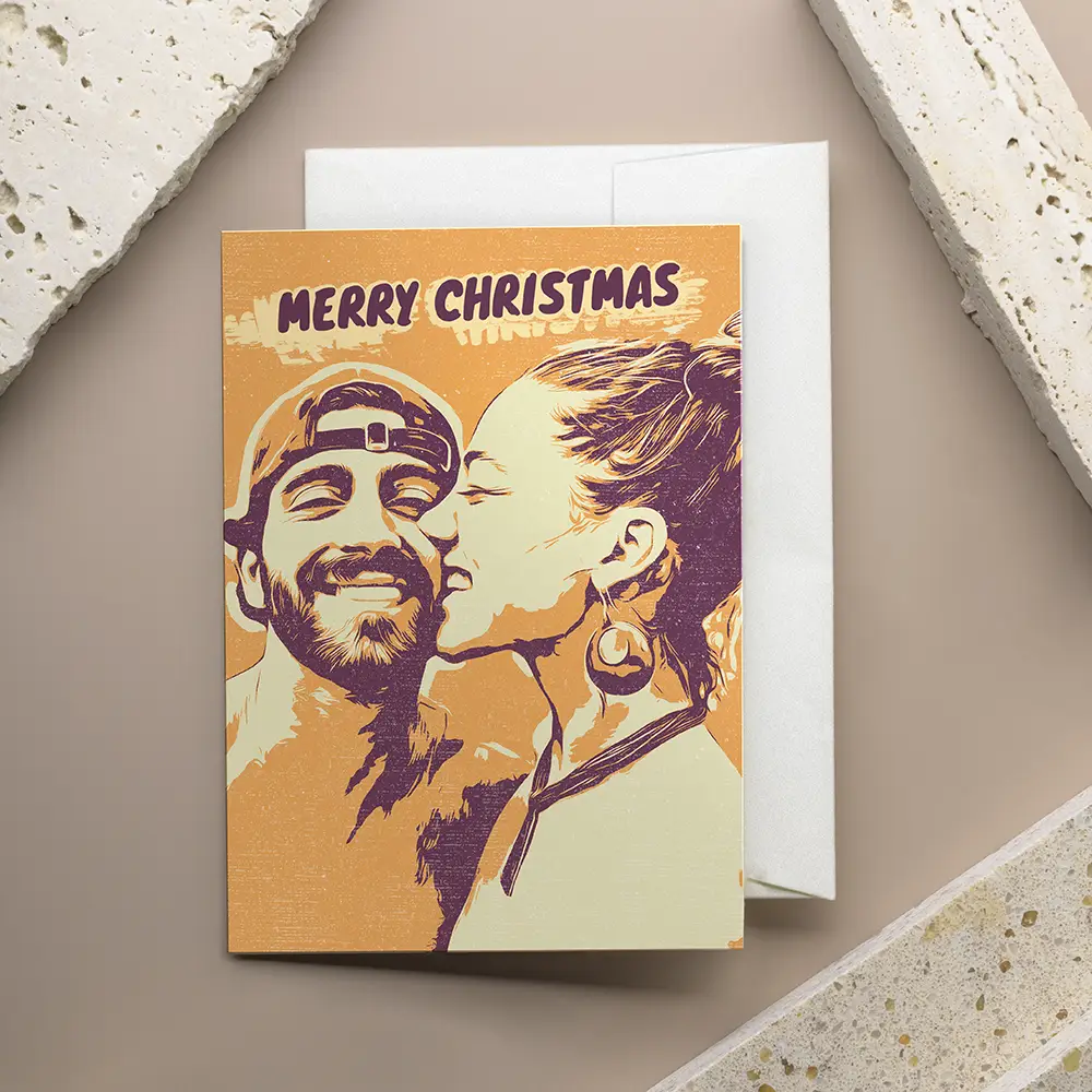 christmas card with a picture of a man and a woman kissing