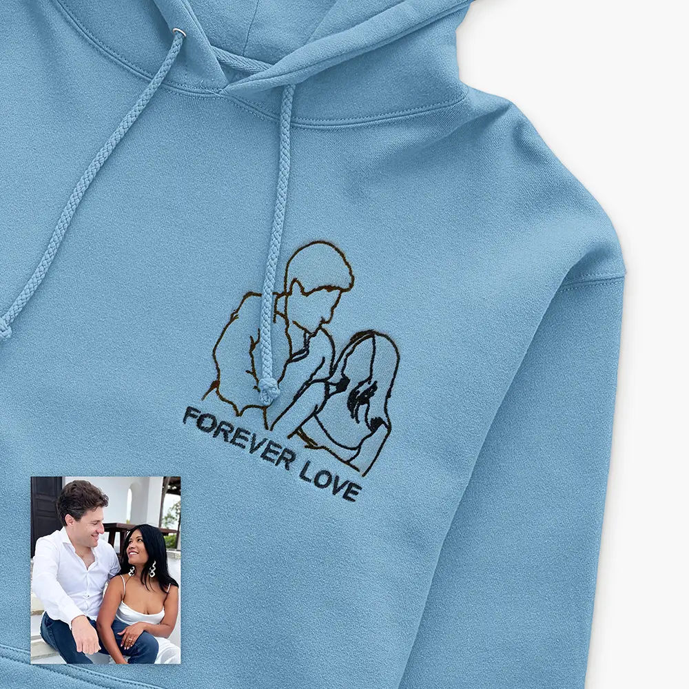a blue hoodie with a picture of a man and woman on it