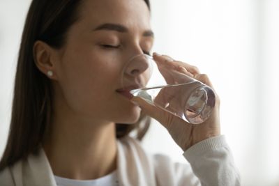 Close-up of a woman enjoying a glass of water