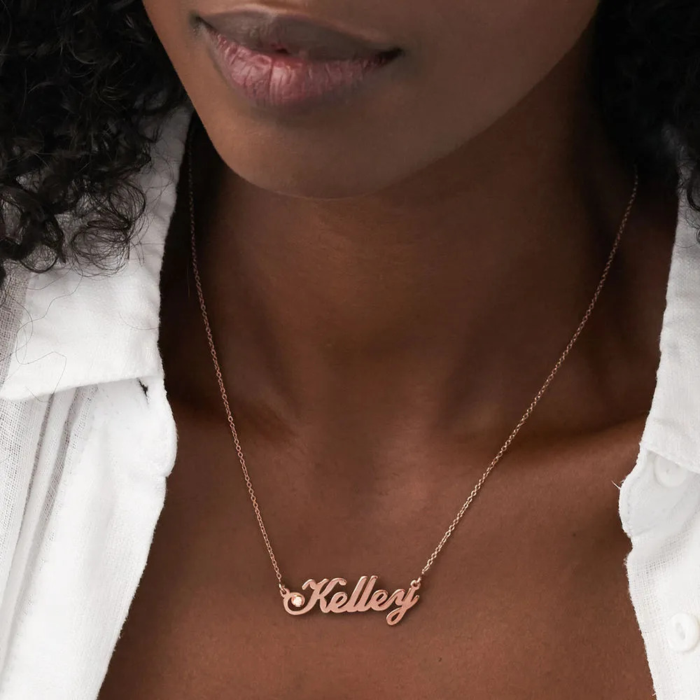 Woman wearing a rose gold plated necklace with a name pendant and diamond details