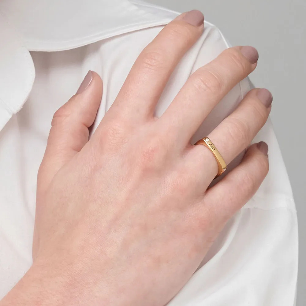 Woman wearing a square ring with an inscription 