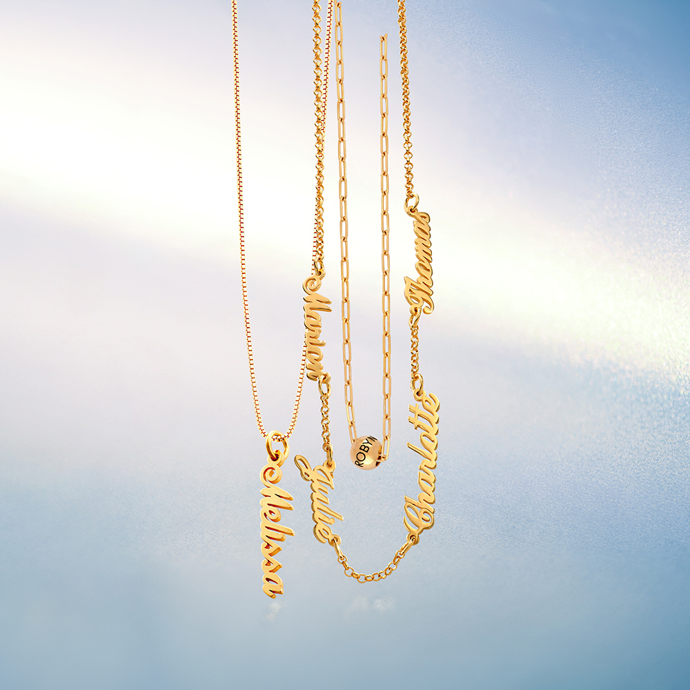 3 Gold necklaces hanging on a blue background