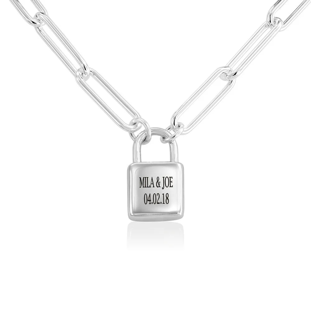 A sterling silver chain link bracelet with an engraved  padlock charm 