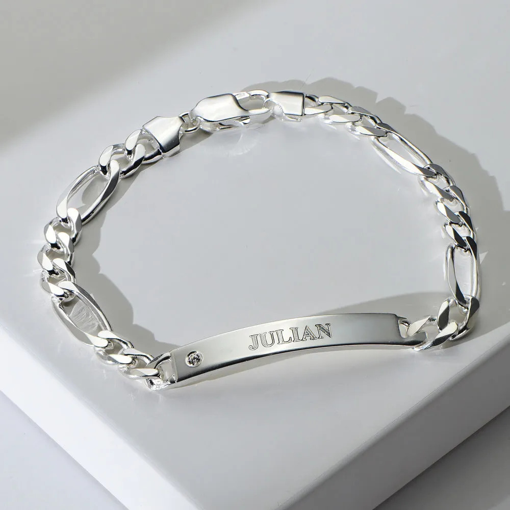 A sterling silver bracelet with an engraved pendant 