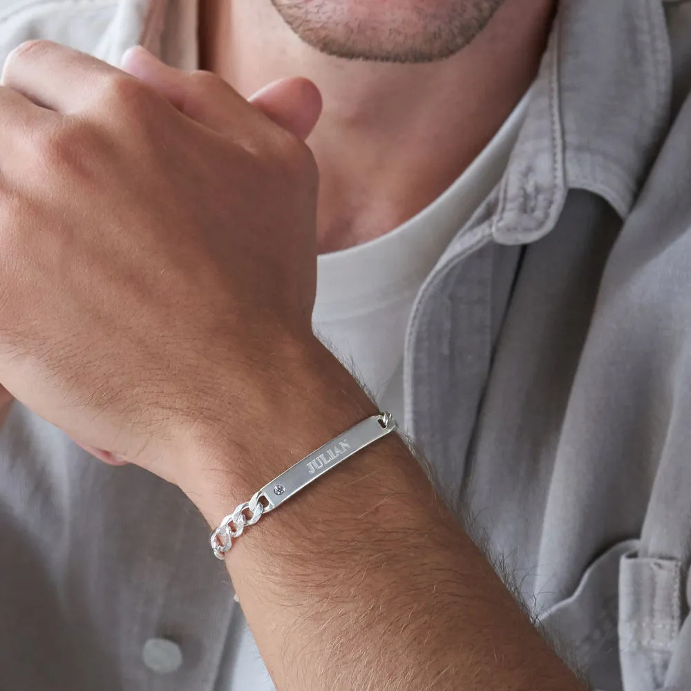 Man wearing a sterling silver bracelet with engraving and diamond 