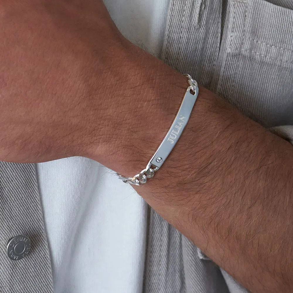 Man wearing a sterling silver bracelet with engraving and diamond 