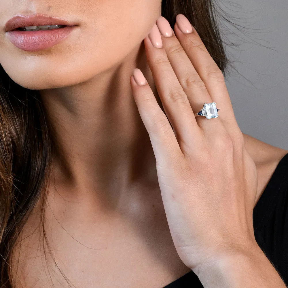 Woman wearing a Sterling silver ring with Acquamarine diamonds 