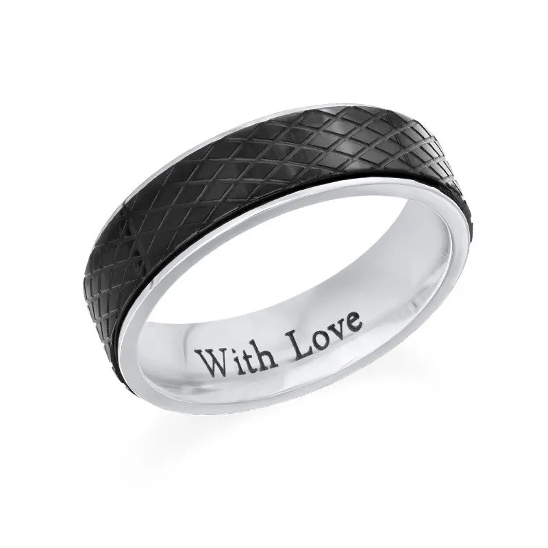 Stock image of a Vertical  Black and silver stainless steel ring with an inscription 
