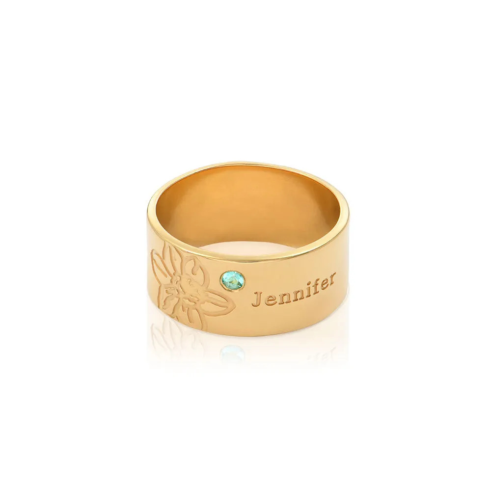 Stock Image of a gold plated ring with  an inscription and  gemstone 