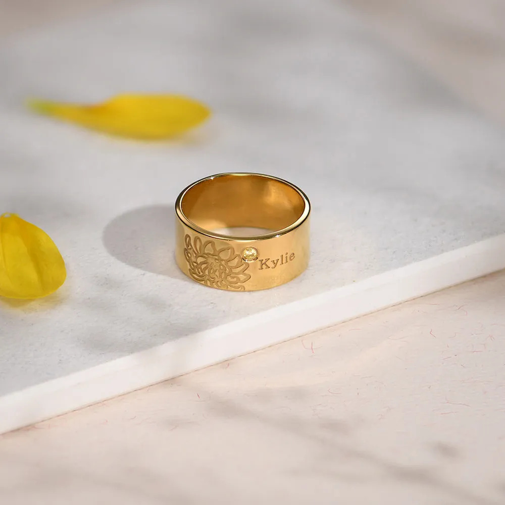 Stock Image of a Gold plated ring with an inscription and gemstone 