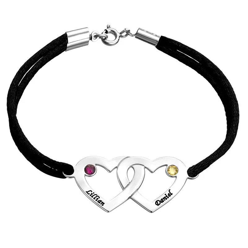 A thin cord bracelet with interlocking heart charms with birthstones 