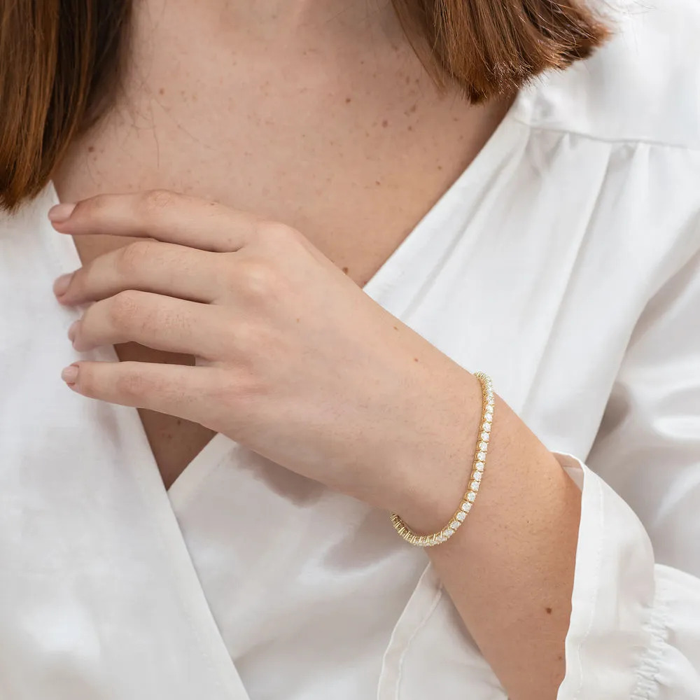 Woman wearing a Created Moissanite Tennis Bracelet in Yellow Silver on her wrist 