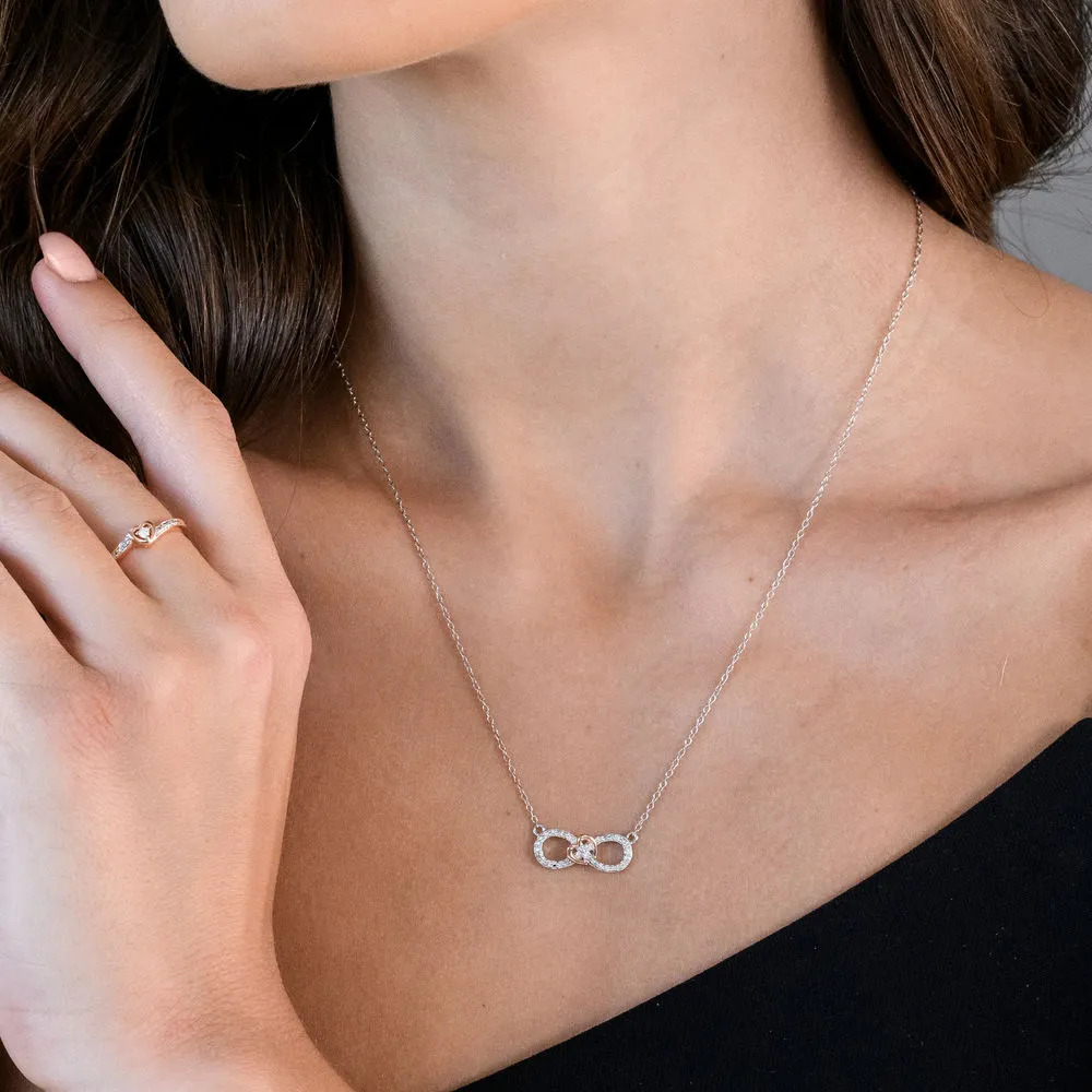 woman wearing a sterling silver necklace with a diamond infinity pendant 