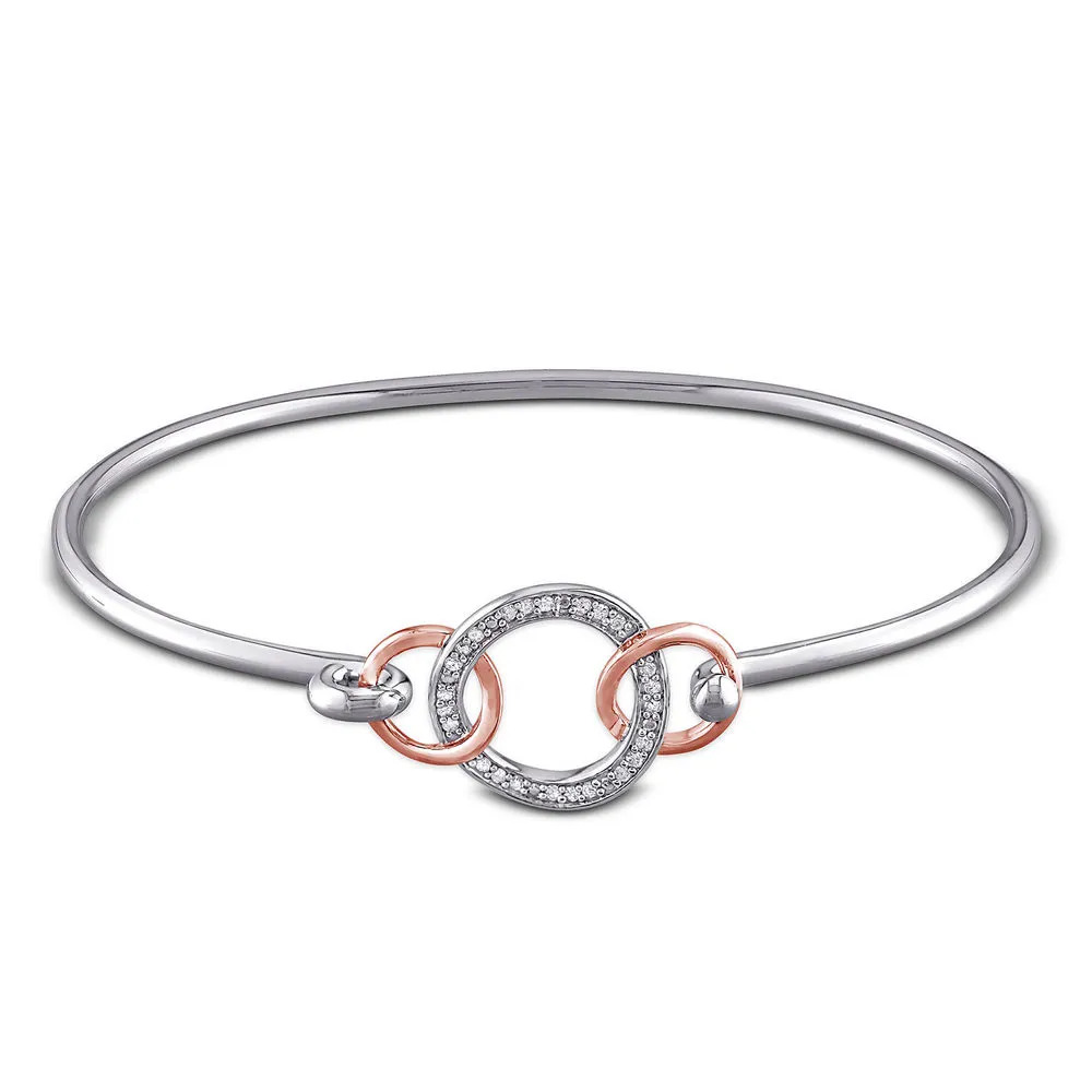 Stock image of a sterling silver  bangle with rose gold and diamond detailing 