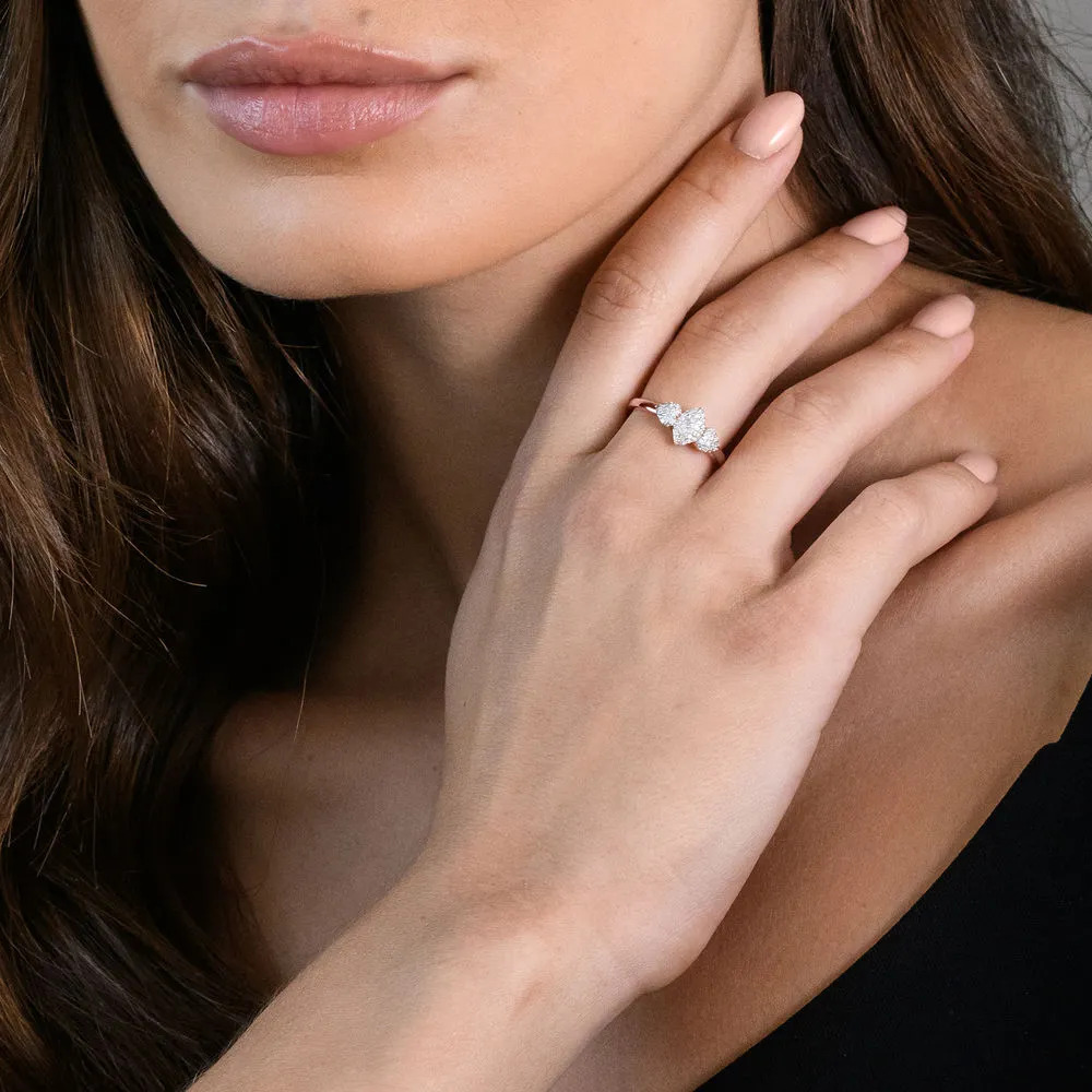 Woman wearing a rose gold plated sterling silver ring with diamond detailing on her middle finger 