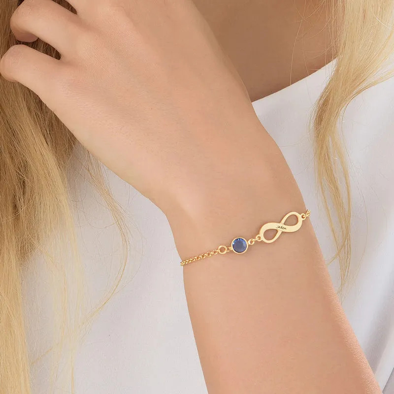 Woman wearing a  Gold Plated Infinity Birhtstone Bracelet