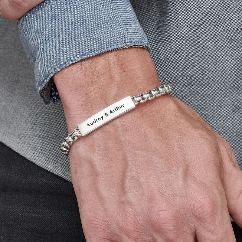 Man wearing a sterling silver bracelet with an inscription 