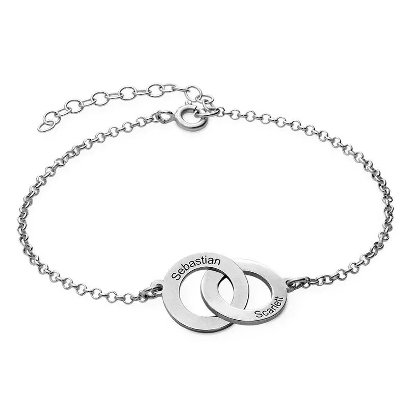A sterling silver bracelet with interlocking charms with engraving 