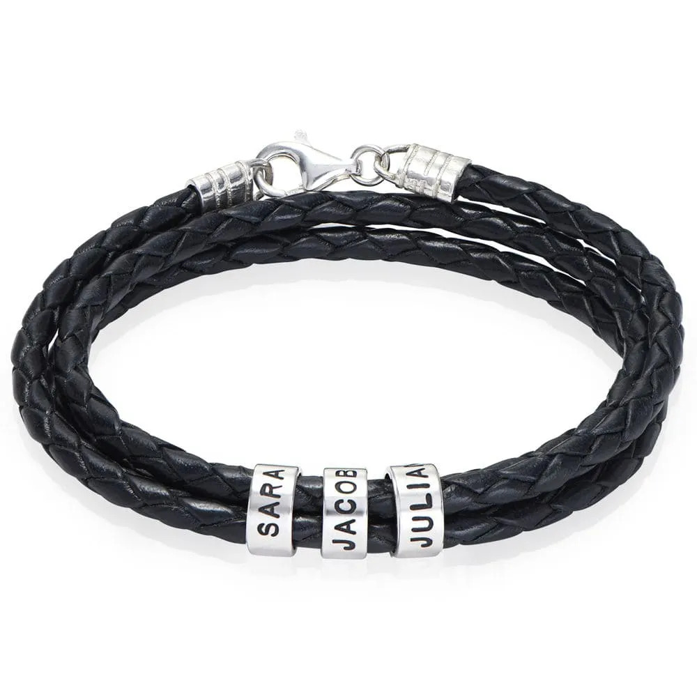Stock Image of a braided leather bracelet with inscribed silver beads 
